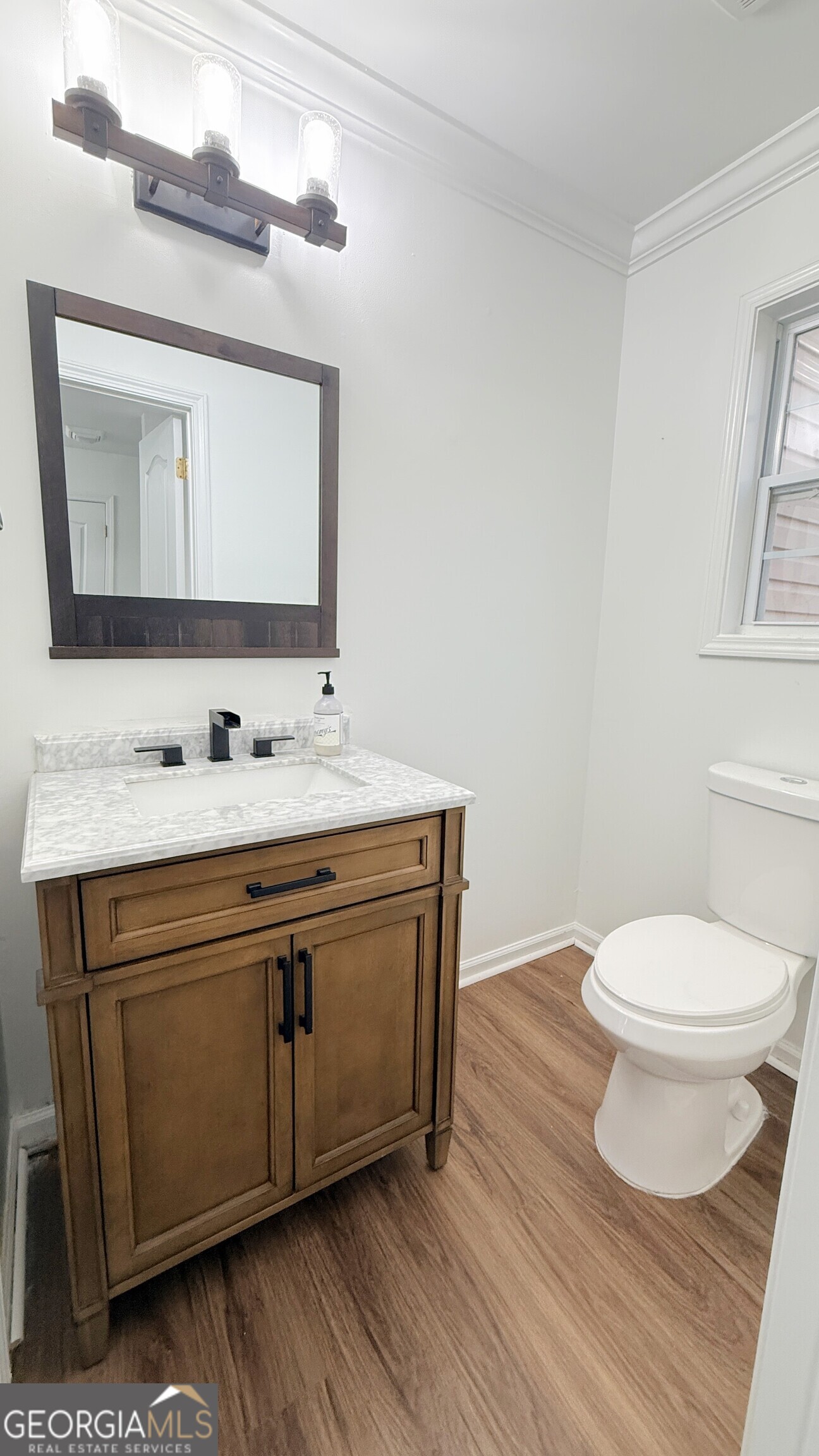 3395 Woodlake Lane Villa Rica, GA 30180 - Photo 19 of 25 a bathroom with a sink vanity and a mirror