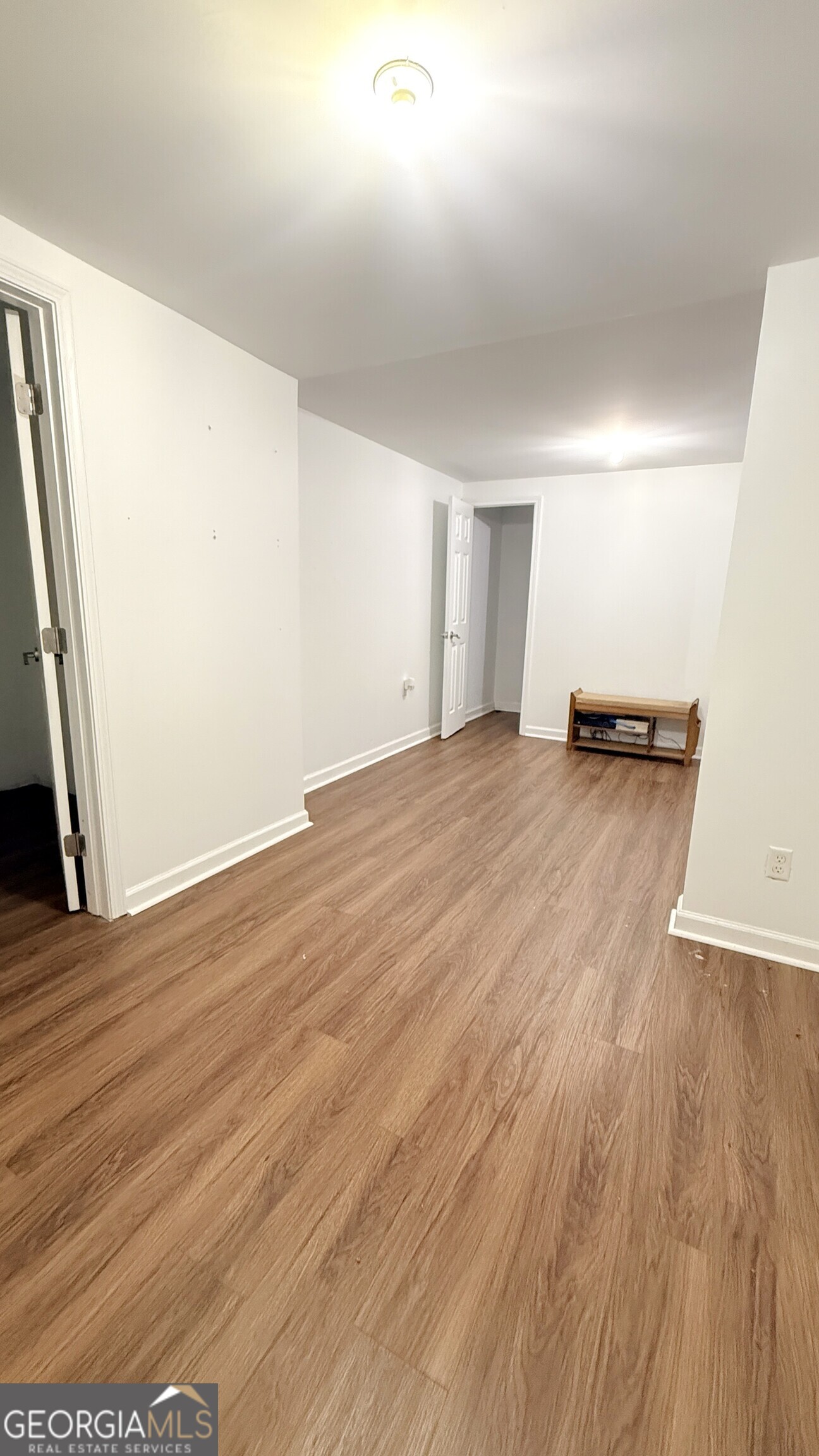 3395 Woodlake Lane Villa Rica, GA 30180 - Photo 21 of 25 an empty room with wooden floor and entrance