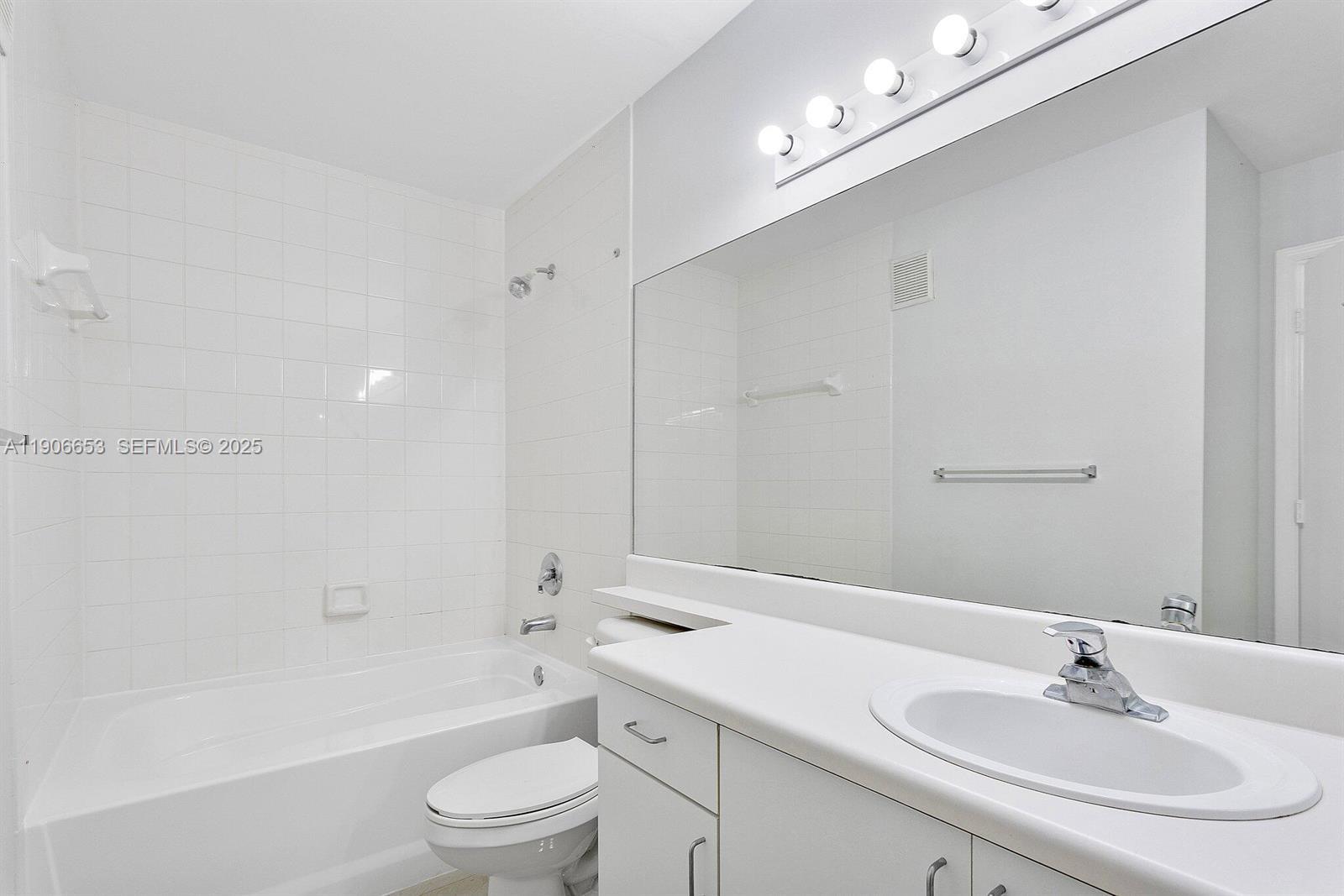 4852 Highway 7, Unit 303 Coconut Creek, FL 33073 - Photo 9 of 26 a bathroom with a sink a toilet and shower