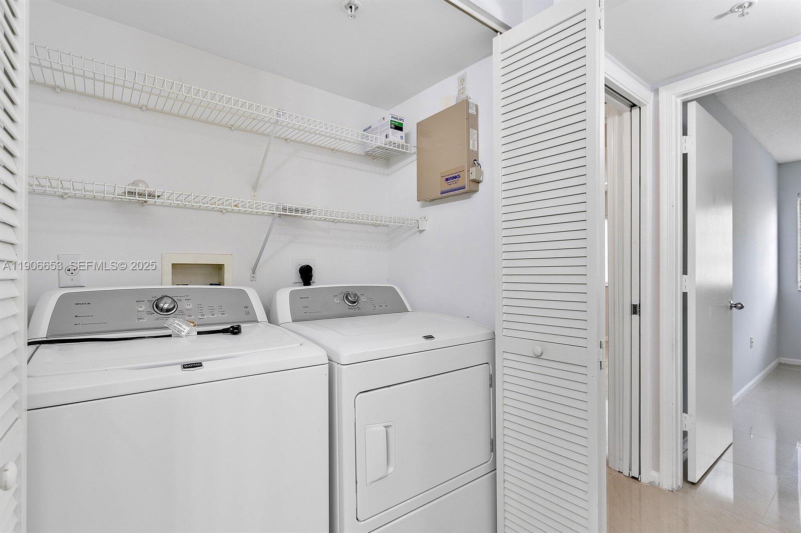 4852 Highway 7, Unit 303 Coconut Creek, FL 33073 - Photo 10 of 26 a utility room with dryer and washer