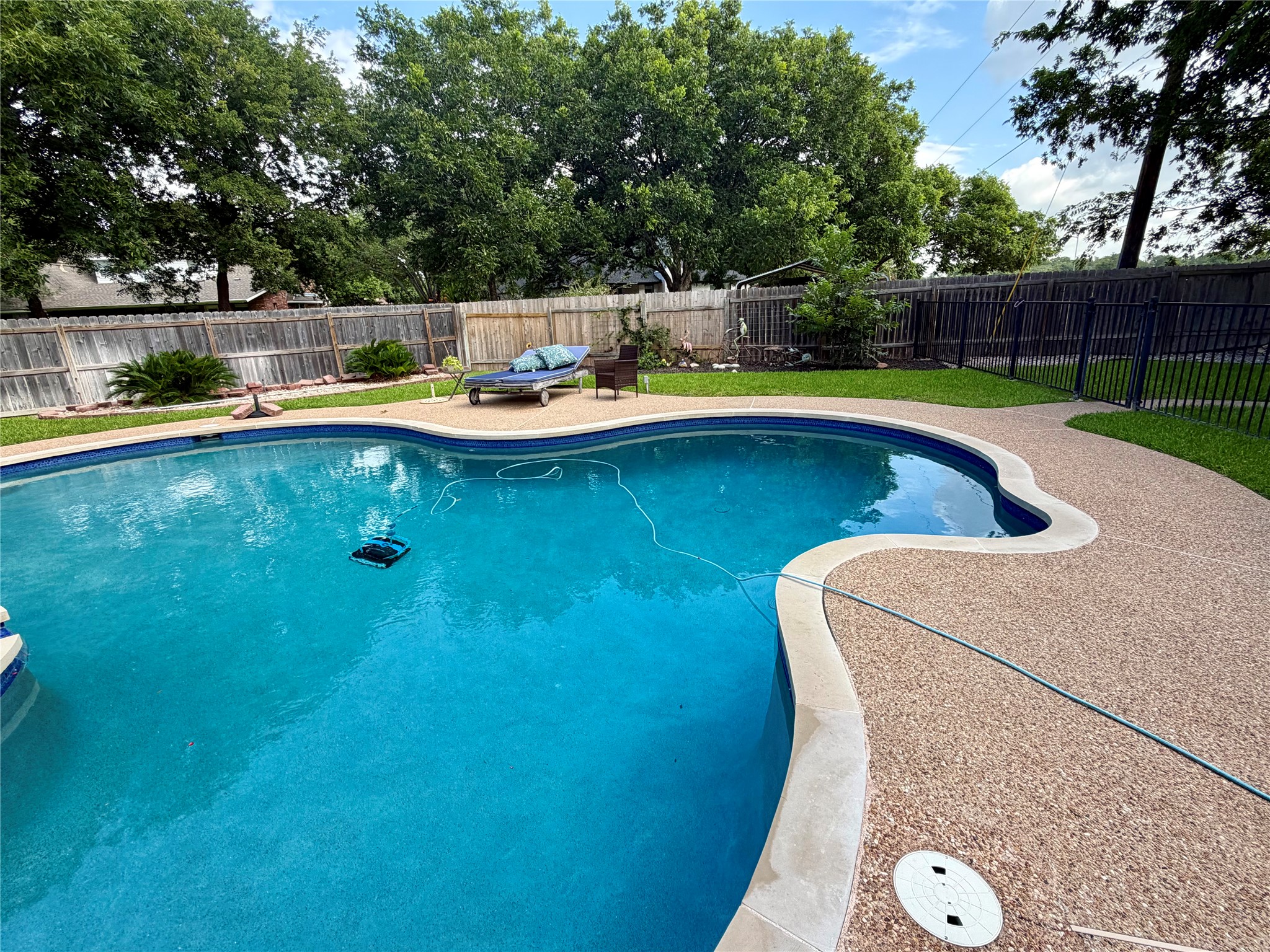 13 Oak View Round Rock, TX 78664 - Photo 5 of 30 An inviting backyard oasis offers a sparkling in-ground pool, perfect for leisure and recreation.