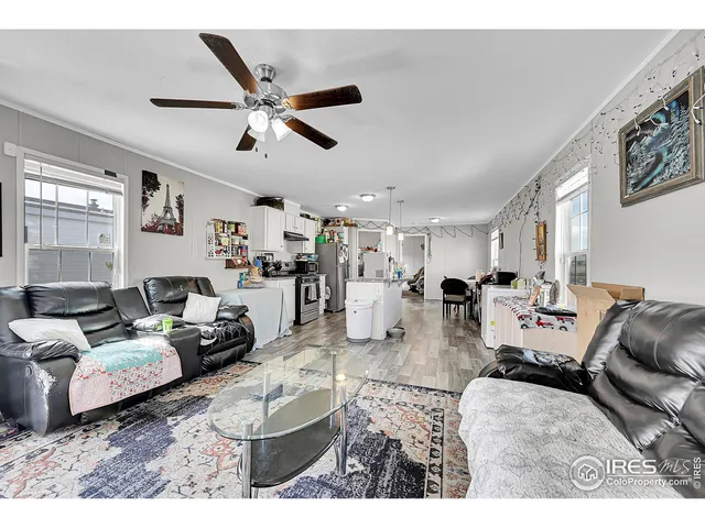 a living room with lots of furniture and white walls