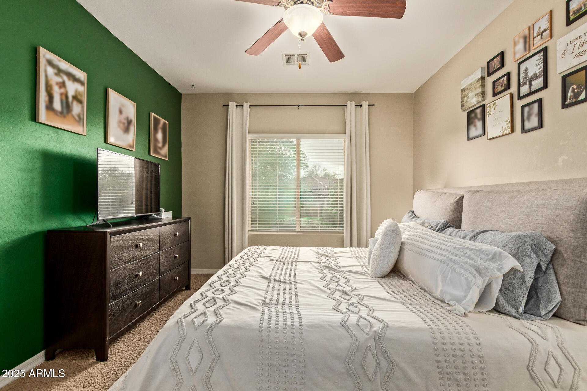 7726 East Baseline Road, Unit 234 Mesa, AZ 85209 - Photo 11 of 31 a spacious bedroom with a large bed and a flat tv screen on dresser