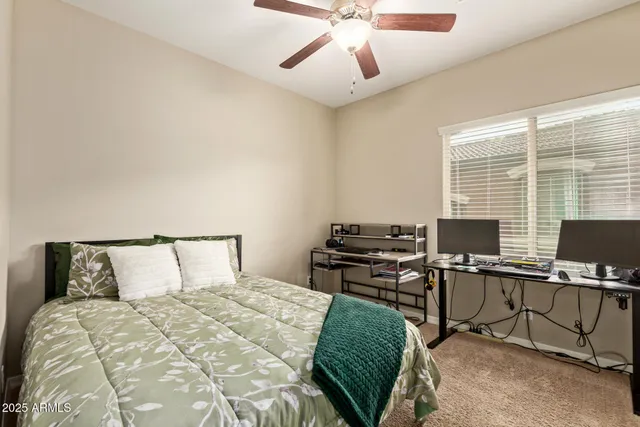 a bedroom with a bed and a desk