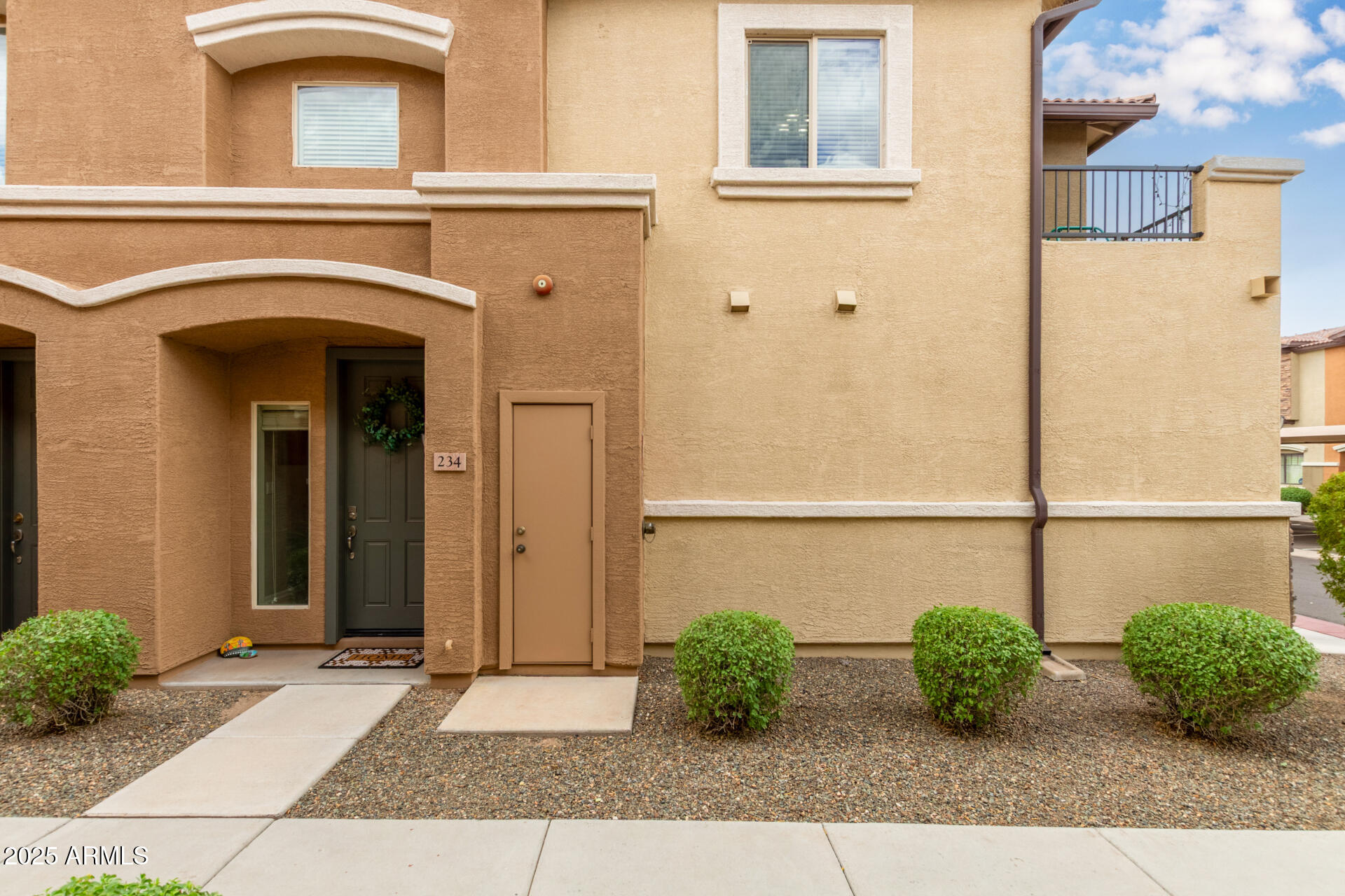 7726 East Baseline Road, Unit 234 Mesa, AZ 85209 - Photo 23 of 31 a view of a house with potted plants