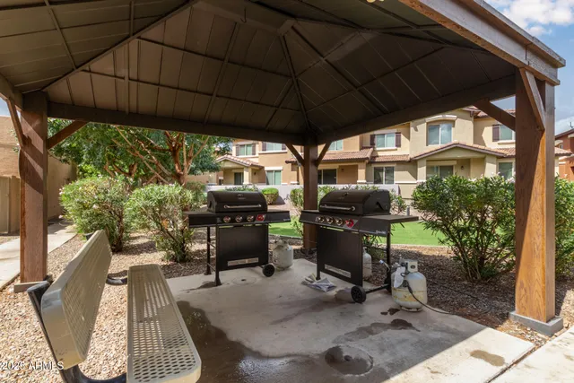 a backyard of a house with table and chairs