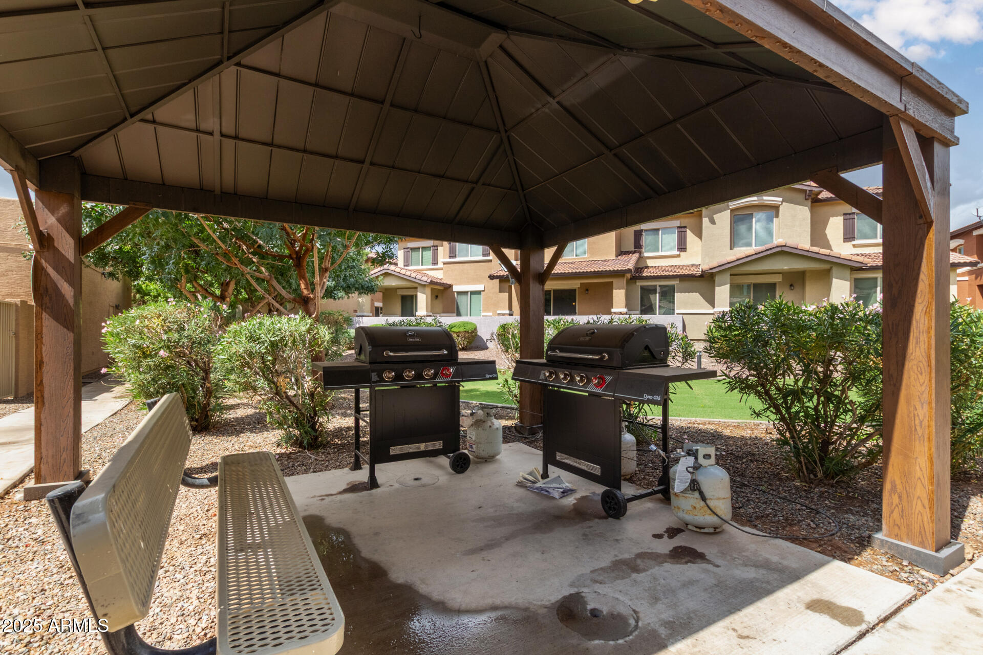 7726 East Baseline Road, Unit 234 Mesa, AZ 85209 - Photo 28 of 31 a backyard of a house with table and chairs