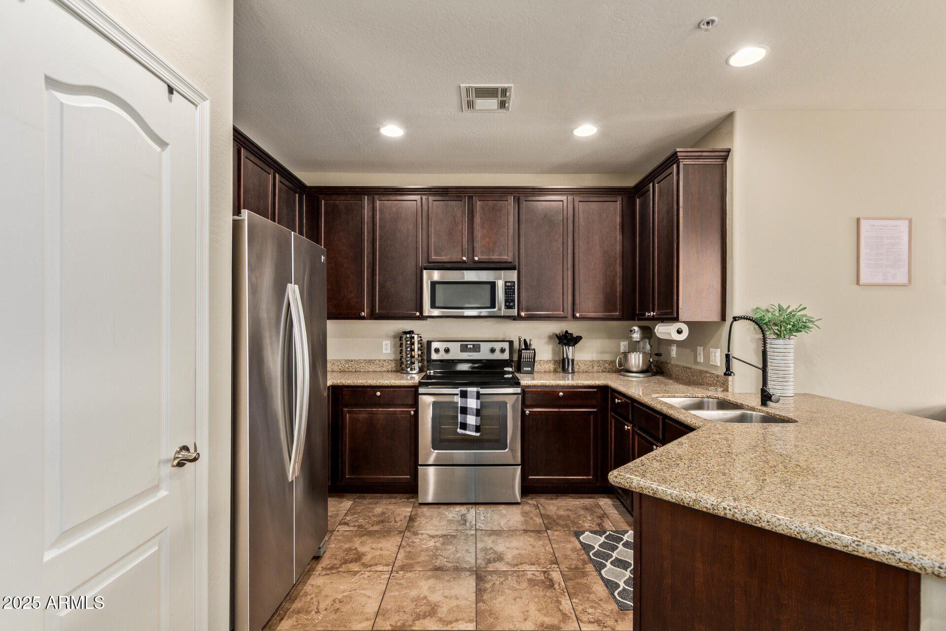 7726 East Baseline Road, Unit 234 Mesa, AZ 85209 - Photo 5 of 31 a kitchen with kitchen island granite countertop stainless steel appliances and sink