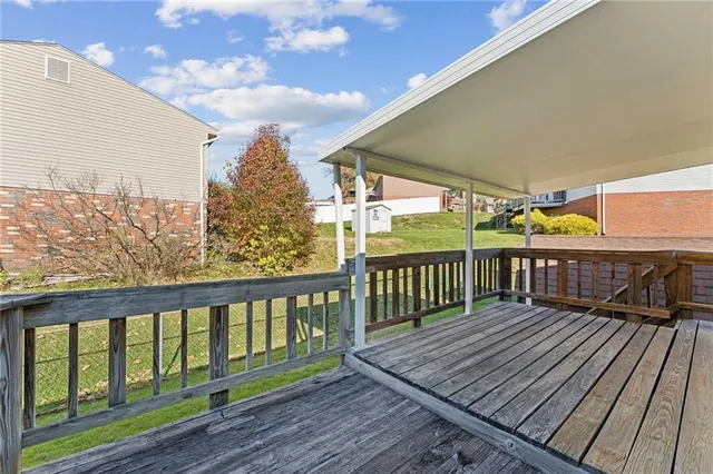 a view of a balcony with wooden floor