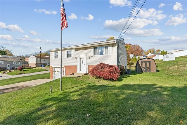 a view of a house with a backyard