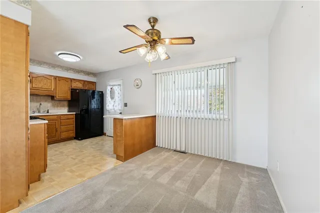 a view of a kitchen with a sink cabinets and stainless steel appliances