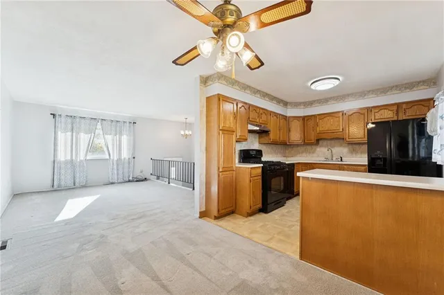 a large kitchen with cabinets and stainless steel appliances