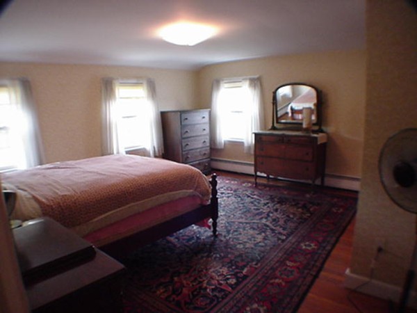 33 Stowecroft Road Arlington, MA 02474 - Photo 9 of 30 a bedroom with a bed and a dresser with mirror