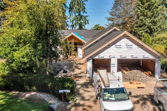 an aerial view of a house with a yard