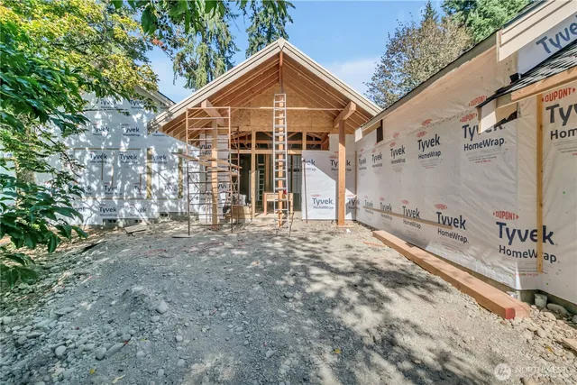 a view of a hallway with wooden floor and entryway