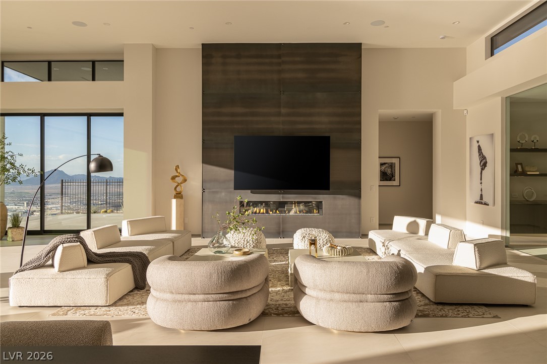 563 Grand Rim Drive Henderson, NV 89012 - Photo 4 of 70 A refined great room with a linear fireplace and tall glass doors offers expansive views.