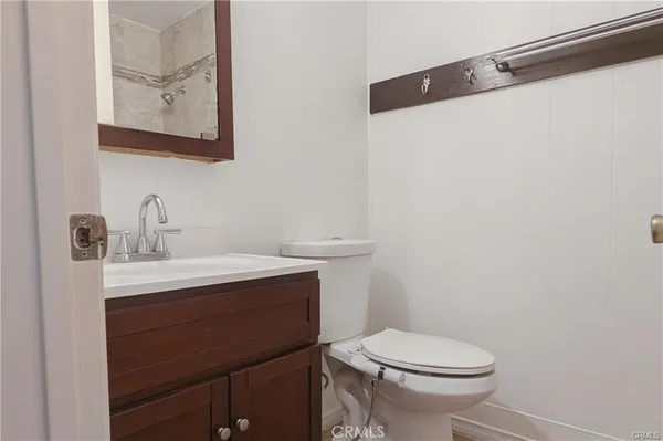 a bathroom with a sink a toilet and mirror