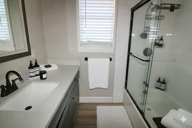 a bathroom with a tub sink and mirror