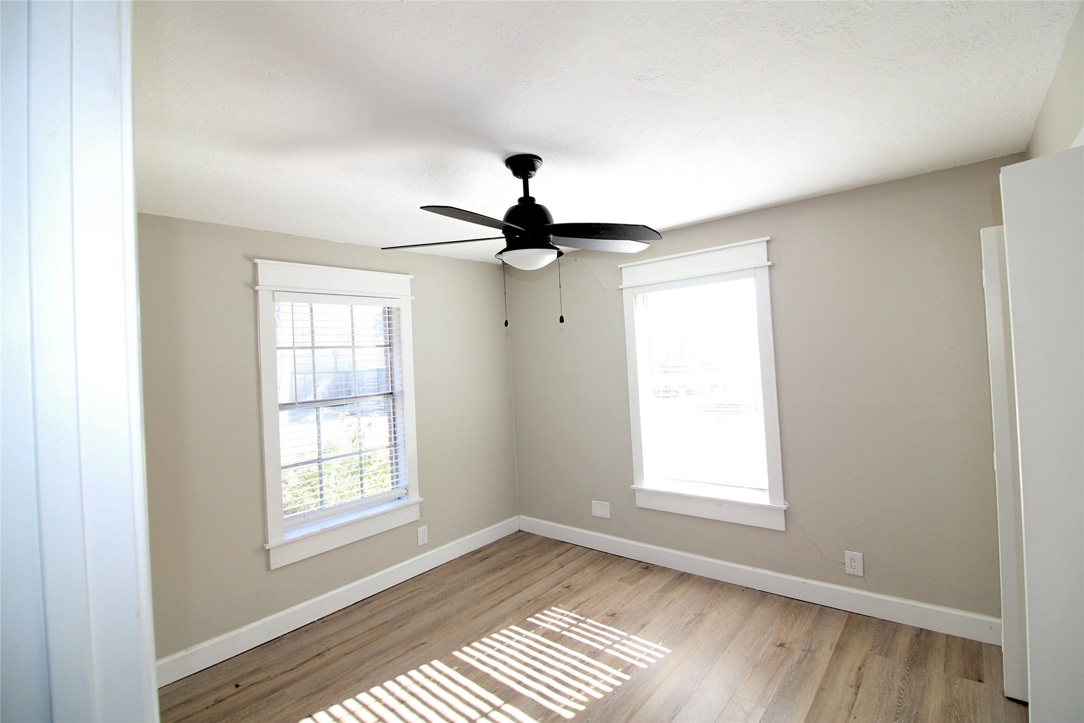 1305 Adams Street, Unit 7 Conroe, TX 77301 - Photo 5 of 12 a view of empty room with wooden floor and fan