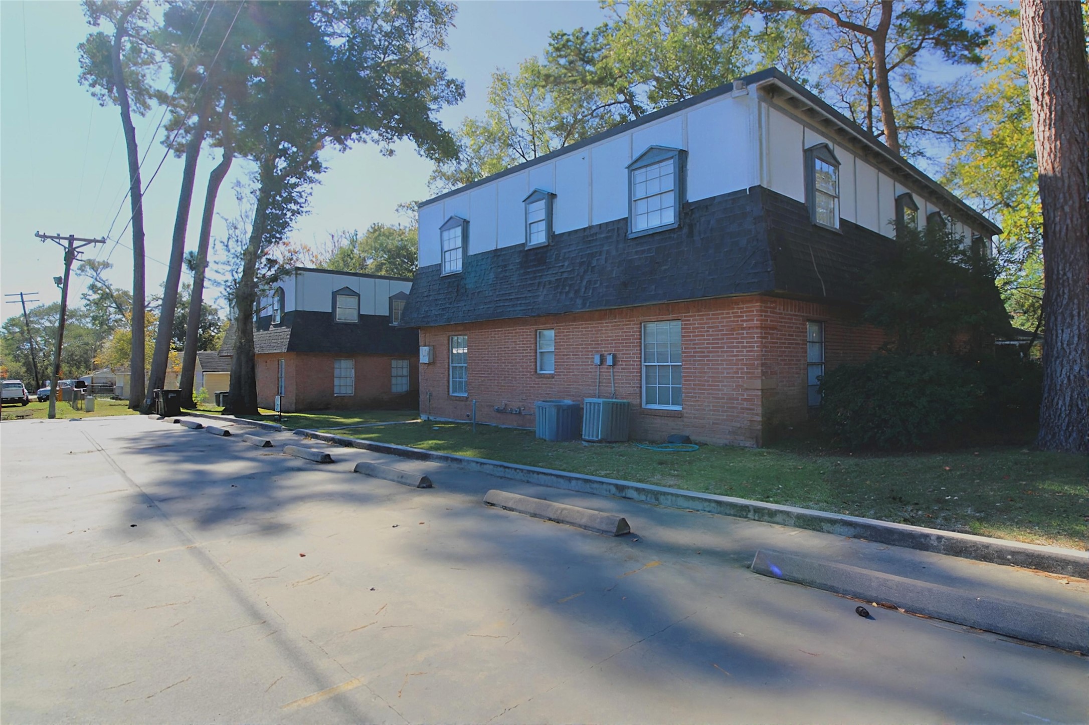 1305 Adams Street, Unit 7 Conroe, TX 77301 - Photo 8 of 12 a front view of a house with a yard and a garage