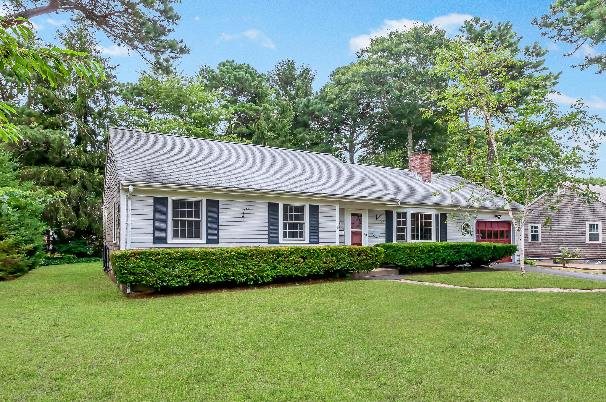 64 Taft Road West Yarmouth, MA 02673 - Photo 2 of 21 a front view of a house with a garden