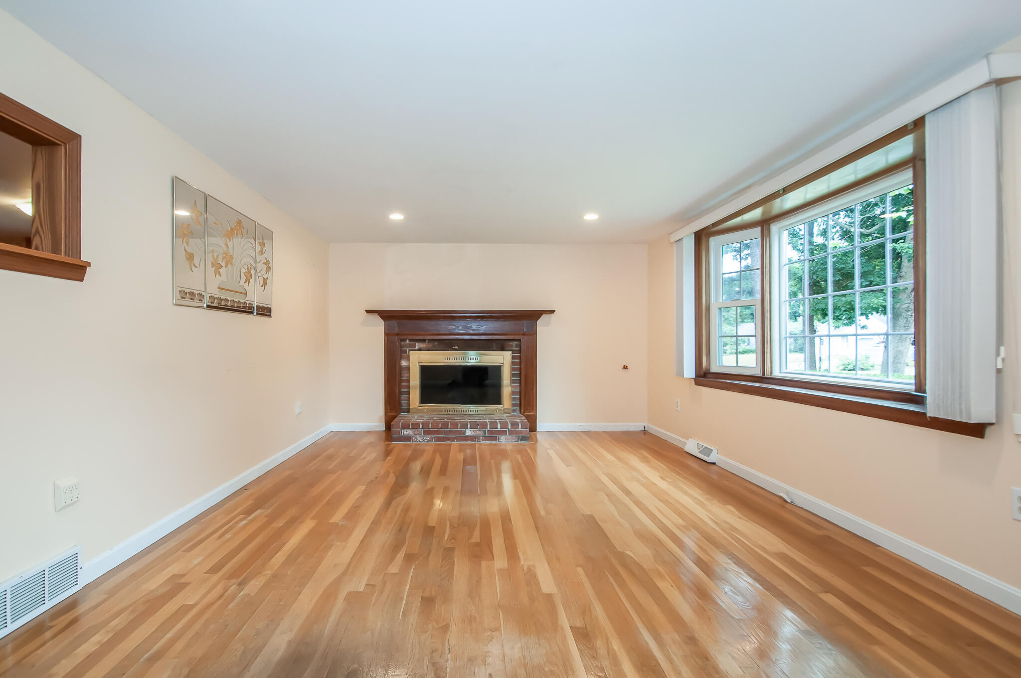 64 Taft Road West Yarmouth, MA 02673 - Photo 4 of 21 a view of empty room with wooden floor and fireplace