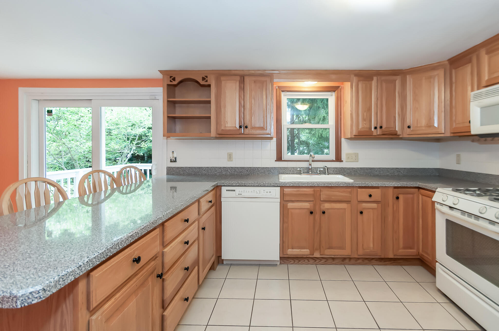 64 Taft Road West Yarmouth, MA 02673 - Photo 7 of 21 a kitchen with granite countertop a stove a sink dishwasher and cabinets next to a window