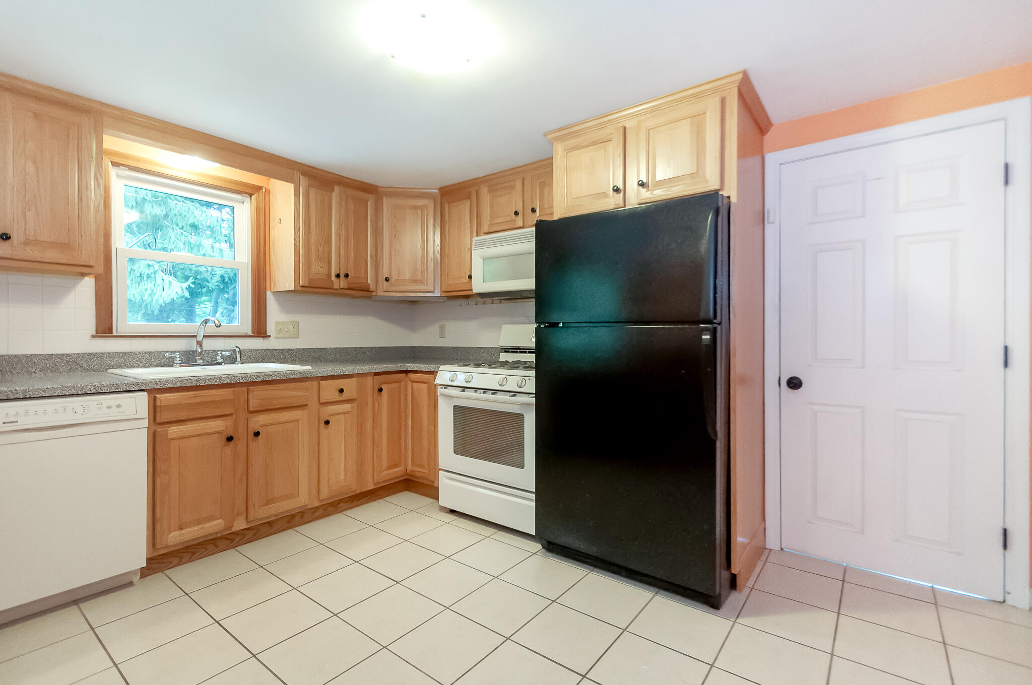64 Taft Road West Yarmouth, MA 02673 - Photo 8 of 21 a kitchen with a refrigerator sink and cabinets