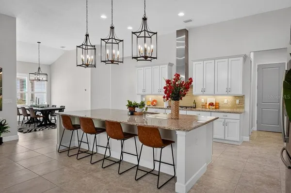 a living room with furniture a fireplace and a potted plant