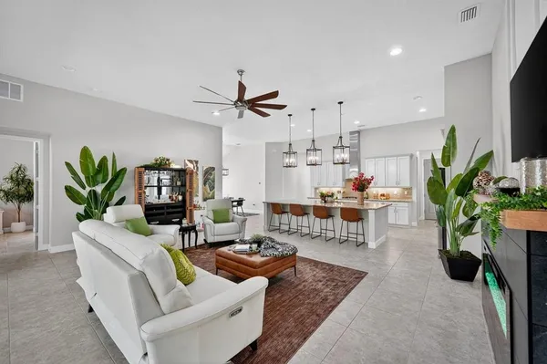 a living room with furniture fireplace and flat screen tv