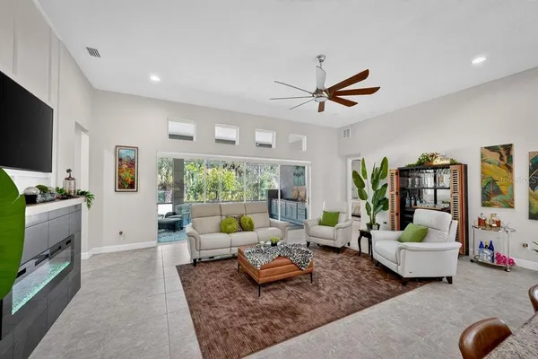 a living room with furniture and wooden floor