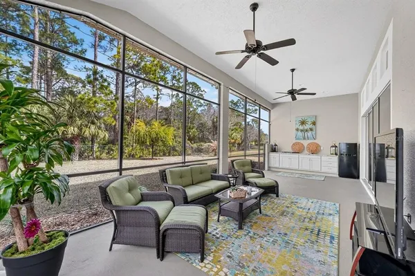 a living room with furniture and a floor to ceiling window