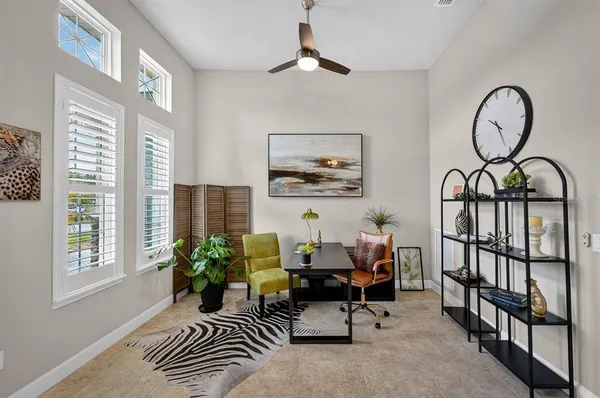 a bedroom with a large bed and a potted plant