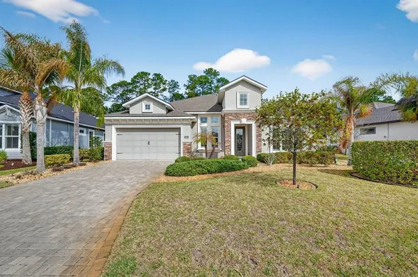 an aerial view of a house with a yard and lake view