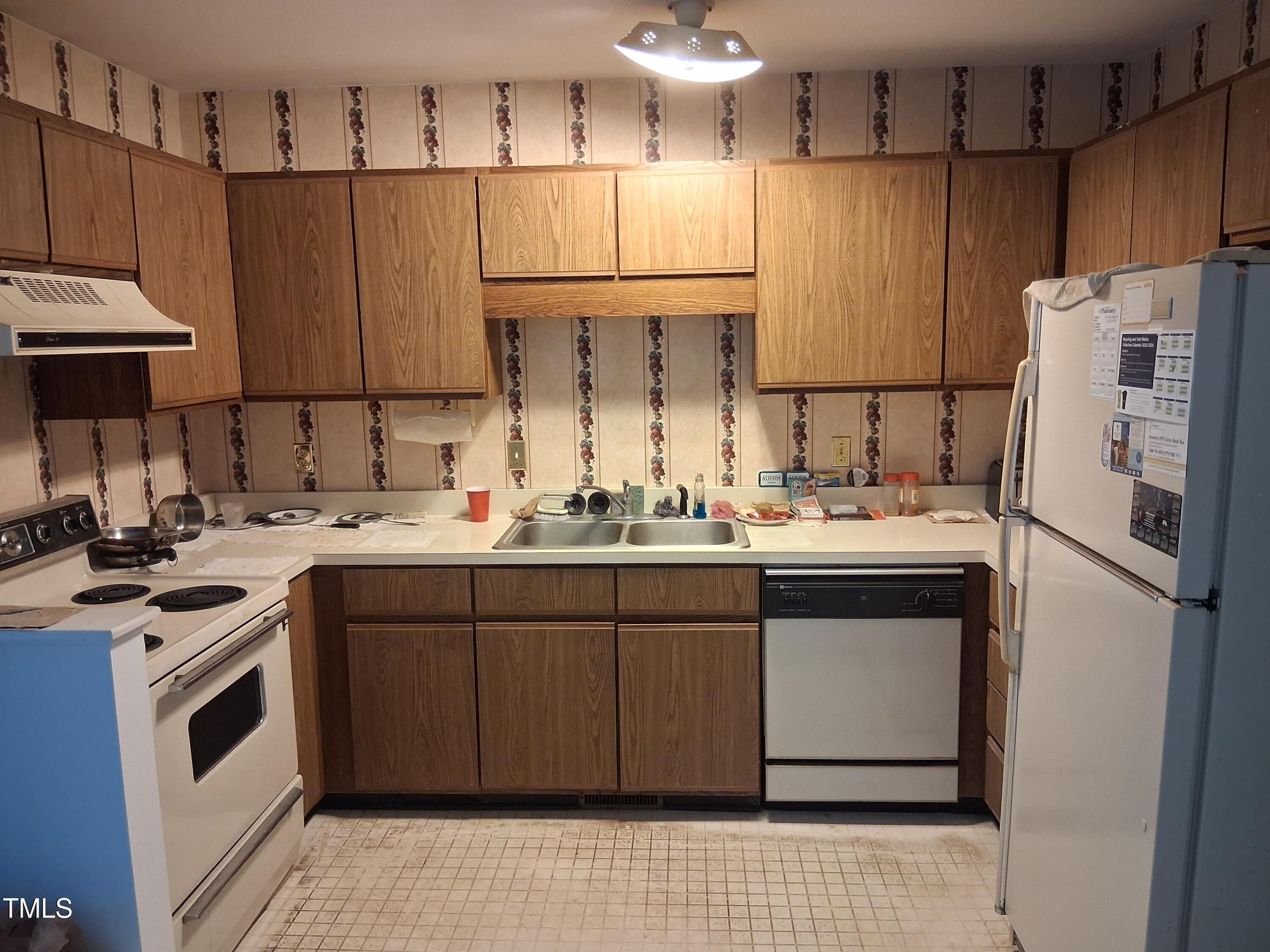 6014 Farm Gate Road Raleigh, NC 27606 - Photo 2 of 3 a kitchen with a sink appliances and cabinets