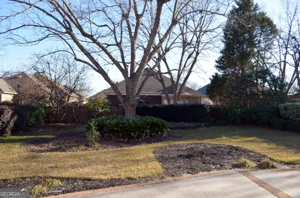 a view of a house with a yard and garden