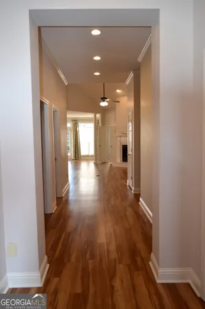 a view of a hallway with wooden floor