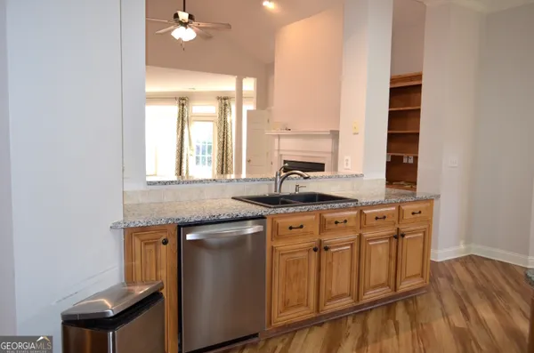 a kitchen with sink cabinets and wooden floor