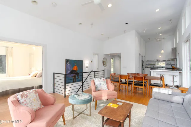 a bedroom with a bed lamp and a large window