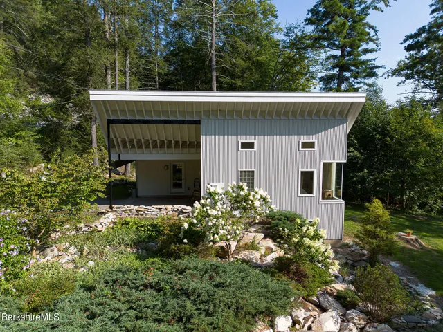 a living room with furniture and large windows