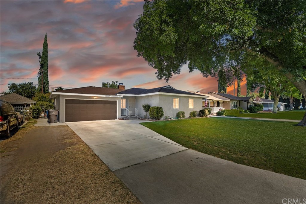 5555 Tower Road Riverside, CA 92506 - Photo 1 of 1 a front view of a house with a garden and yard