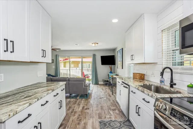 a kitchen with a sink stove and cabinets