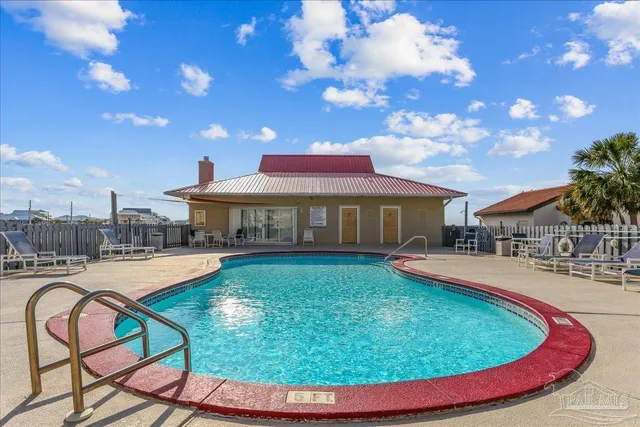 a view of a swimming pool with a table and chairs