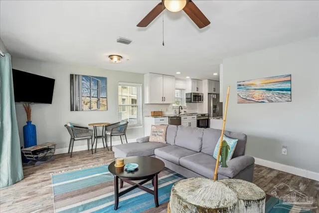 a living room with furniture a rug and a flat screen tv