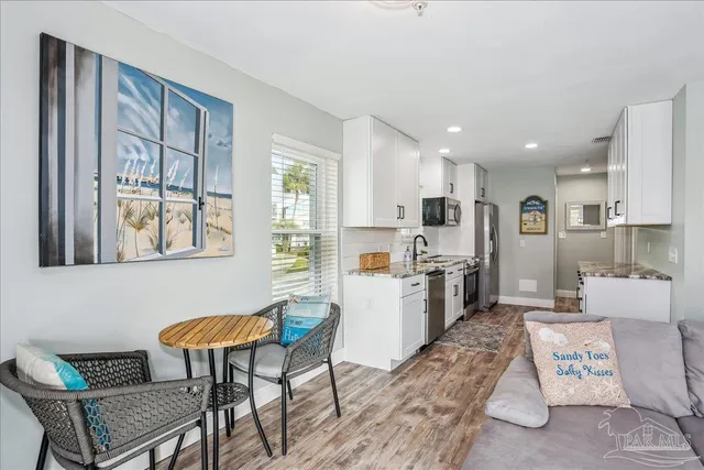 a kitchen with a refrigerator and a dining table