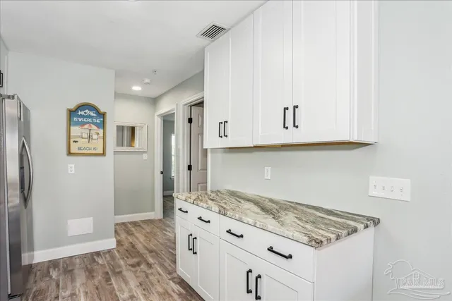 a kitchen with stainless steel appliances granite countertop a stove and a refrigerator