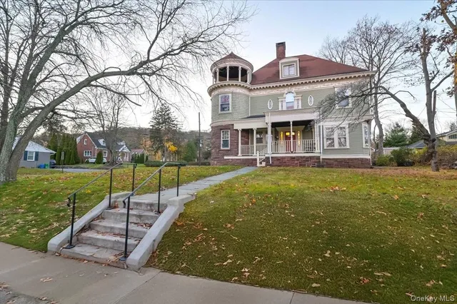 a front view of house with a garden