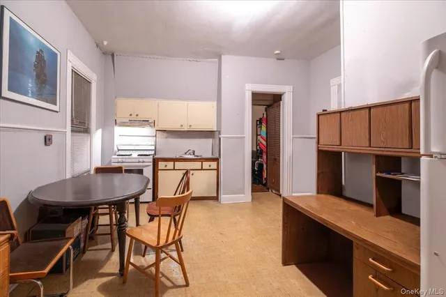 a kitchen with refrigerator cabinets dining table and chairs