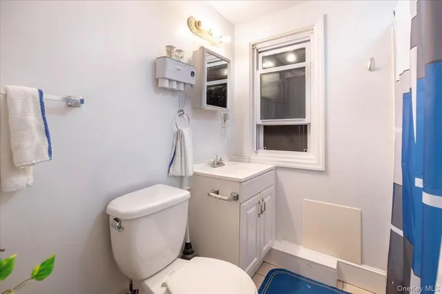 a white toilet sitting next to a bathroom sink