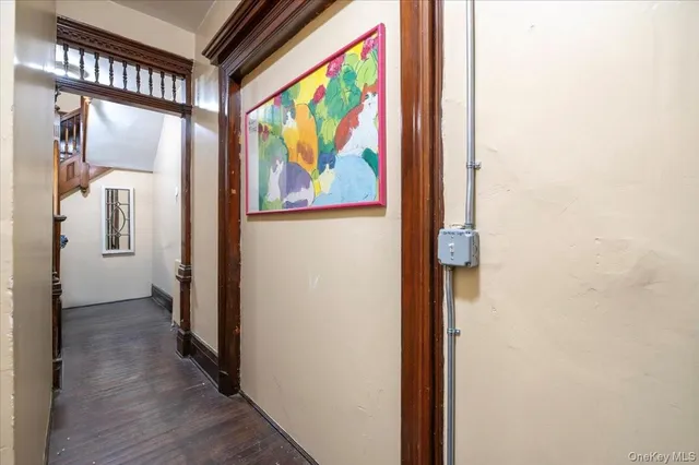 a view of a hallway with wooden floor and door